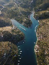 Aerial view of Brac Island in turquoise bay with moored boats, Croatia. - AAEF27852