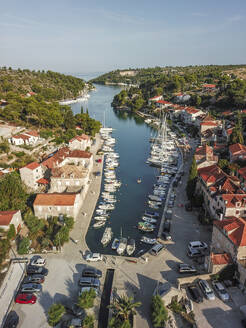 Aerial view of coastal village with marina and sailing boats, Brac Island, Croatia. - AAEF27863
