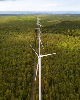 Aerial drone view of wind turbines in a tropical forest, Bras d'Eau National Park, Flacq, Mauritius. - AAEF27925