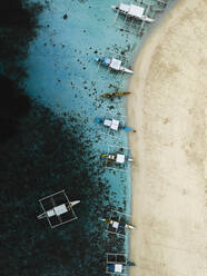 Aerial drone view of long tail touristic boats docked along the naked island Siargao, Surigao del Norte, Philippines. - AAEF27996