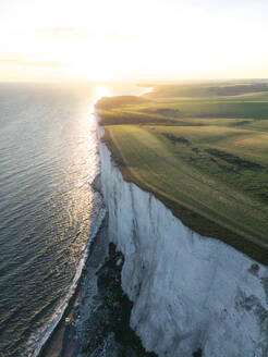 Aerial drone view of the Seven Sisters Cliffs National Park during sunset in the Eastbourne, England, United Kingdom. - AAEF27999