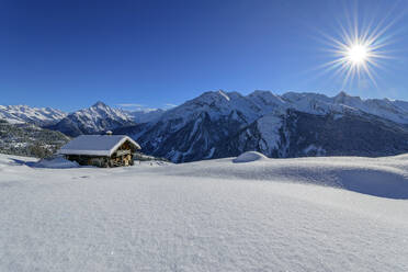 Snow covered cottage at Rastkogel near Zillertal Alps on sunny day, Tux Alps, Tyrol, Austria - ANSF00841