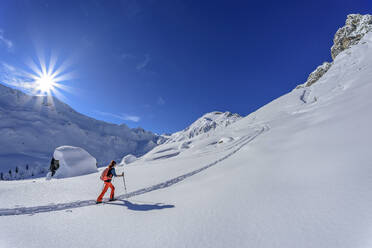 Woman back country skiing on Junsjoch, Tux Alps, Tyrol, Austria - ANSF00847