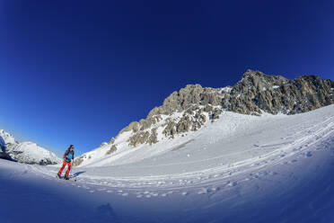 Mature woman back country skiing on Gruenstein, Mieming Range, Tyrol, Austria - ANSF00854