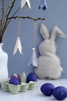Studio shot of purple Easter eggs and DIY paper craft flowers - GISF01044