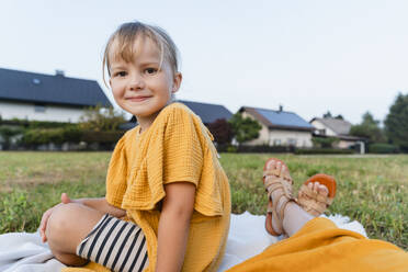 Smiling girl sitting with mother in meadow - NDEF01608