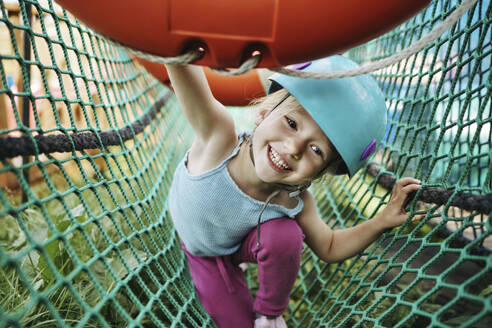 Happy girl having fun playing at rope park - NSTF00062