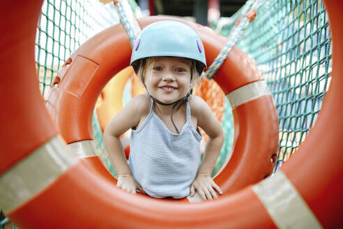 Smiling girl playing at rope park - NSTF00065