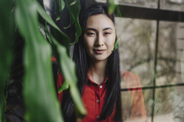 Young woman photographed through glass window - YTF02049