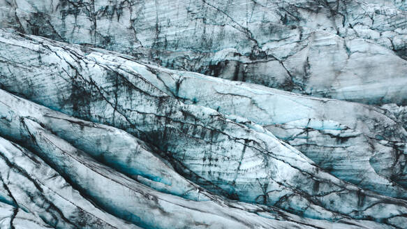Stunning close-up of the blue ice and crevasses of a glacier in Iceland, showcasing nature's artistry. - ADSF53361