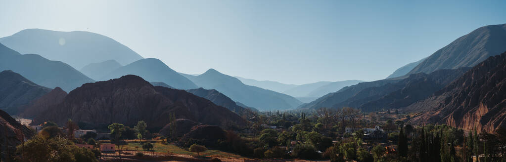 Panoramic view of Purmamarca in northern Argentina, showcasing the verdant village against towering mountains. - ADSF54015