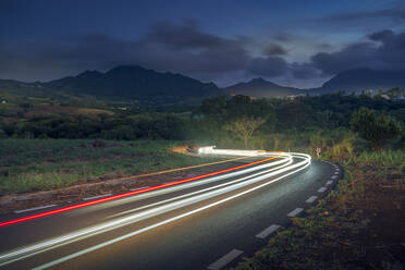 View of trail lights and Long Mountains at dusk near Nouvelle Decouverte, Mauritius, Indian Ocean, Africa - RHPLF32306