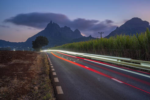 View of trail lights and Long Mountains at dusk near Beau Bois, Mauritius, Indian Ocean, Africa - RHPLF32415