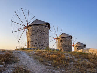 Windmills of Patmos Chora at sunset, Patmos Island, Dodecanese, Greek Islands, Greece, Europe - RHPLF32856