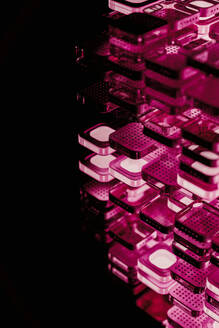 Layers of microchip blocks with illuminated pink light in dark - JPF00499