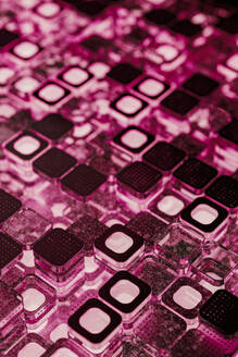 Black microchip blocks illuminated with pink lighting - JPF00501