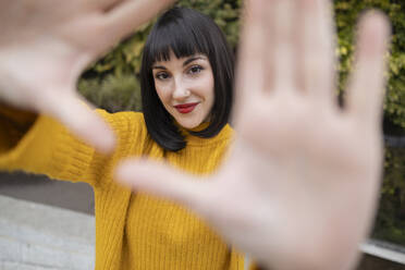 Smiling woman with bangs gesturing - ALZF00011