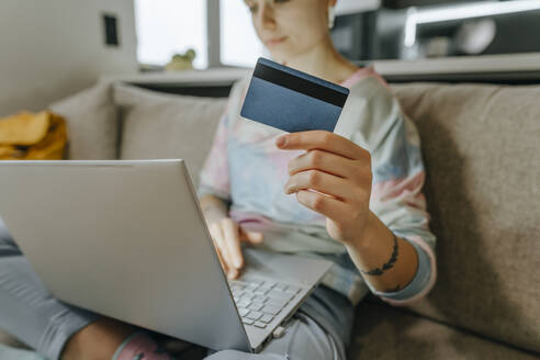 Young woman paying with credit card using laptop at home, woman, home, hairstyle, millennials, individuality, tattoo, laptop, technology, online shopping, bank card, buying - YTF02069