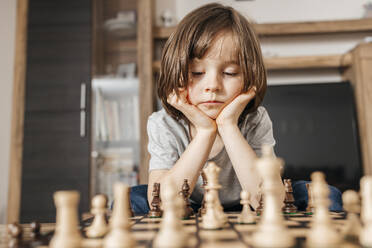 A boy is thinking about his next move in chess. - ELMF00148