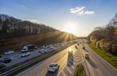 traffic on the highway during sunset, mobility, transportation, multiple Lane Highway, blurred motion, high traffic volume, sunset, backlight, photos were taken from public ground, Munich, Bavaria, Germany - MAMF02961