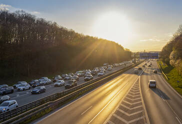 traffic on the highway during sunset, mobility, transportation, multiple Lane Highway, blurred motion, high traffic volume, sunset, backlight, photos were taken from public ground, Munich, Bavaria, Germany - MAMF02962