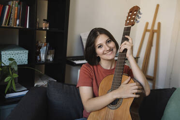 girl with a guitar on the sofa - MCHF00034