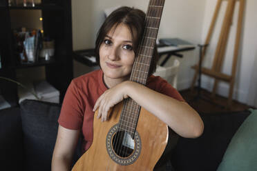 girl with a guitar on the sofa - MCHF00044