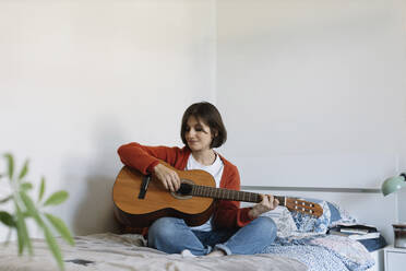 girl with guitar on bed - MCHF00045