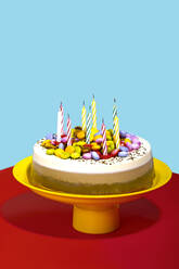 Vibrant still life of chocolate and vanilla birthday cake with colorful toppings and celebration candles - RDTF00086