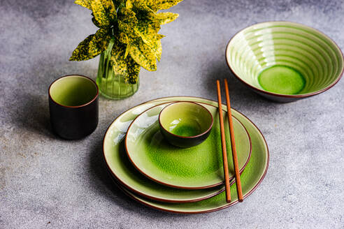 Elegant green ceramic dinner set with chopsticks, showcasing a bright table setting. - ADSF54060