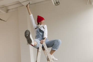 Gdansk, Poland, woman making renovations in her new apartment and dreams - VIVF01285