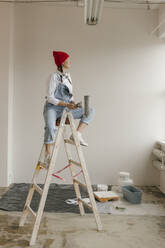 Gdansk, Poland, woman making renovations in her new apartment and dreams - VIVF01287