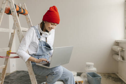 Gdansk, Poland, woman making renovations in her new apartment and dreams, orders and buys materials and furniture online - VIVF01292