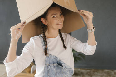 Gdansk, Poland, woman moving to a new place with a lot of boxes and personal belongings - VIVF01300