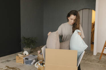 Gdansk, Poland, woman moving to a new place with a lot of boxes and personal belongings - VIVF01301