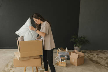 Gdansk, Poland, woman moving to a new place with a lot of boxes and personal belongings - VIVF01302