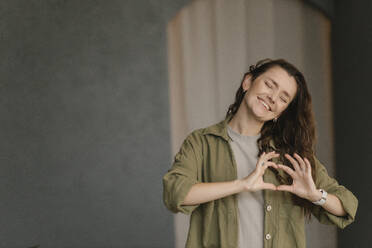 Gdansk, Poland, portrait of a girl on a gray background in a green shirt - VIVF01319