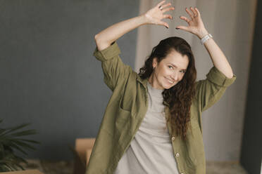 Gdansk, Poland, portrait of a girl on a gray background in a green shirt - VIVF01320