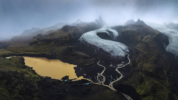 Die rätselhafte Präsenz des Vatnajokull-Gletschers dominiert diese Landschaft mit ihren gewundenen Flüssen und einem milchfarbenen Gletschersee unter einem Nebelschleier - ADSF54749