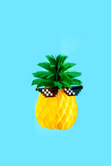 A quirky pineapple donning pixelated sunglasses set against a vibrant blue background. - ADSF54875