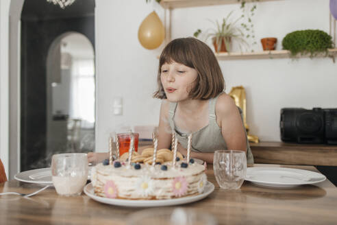 girl blowing out the candles on the cake - ELMF00164