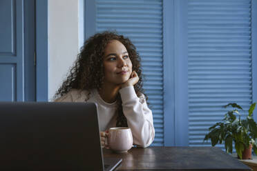 Young woman taking a coffee break from work on her laptop. - SYEF00548