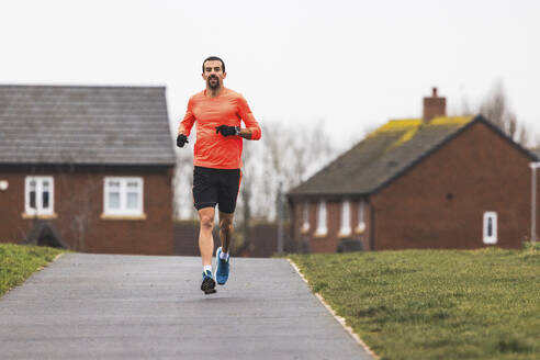 UK, Lichfield, man running outdoors - WPEF08755