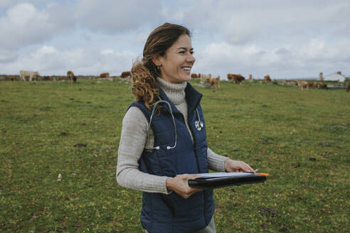 Pozoblanco, Andalusia, Spain - A veterinary woman walking in the countryside controlling animal conditions in livestock farms. - DMGF01318