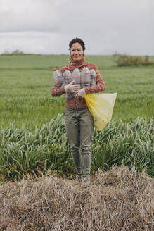 Pozoblanco, Andalusia, Spain - Woman collecting plastic bottles in the countryside. - DMGF01326