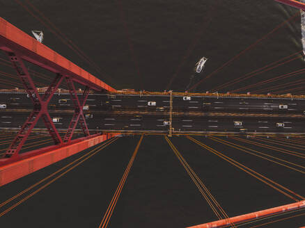 Aerial view of cars crossing the April 25th bridge across the Tagus river in Lisbon, Portugal . - AAEF28440