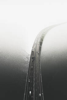 Aerial view of cars passing over the Vasco da Gama bridge across the Tagus river at sunrise, Lisbon, Portugal . - AAEF28444