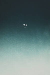 Aerial view of a surfer relaxing in the calm sea in Portugal. - AAEF28587