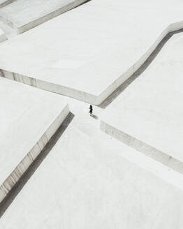 Aerial view of a woman in Cretto di Burri monument line of the white monument in Sicily, Italy. - AAEF28652
