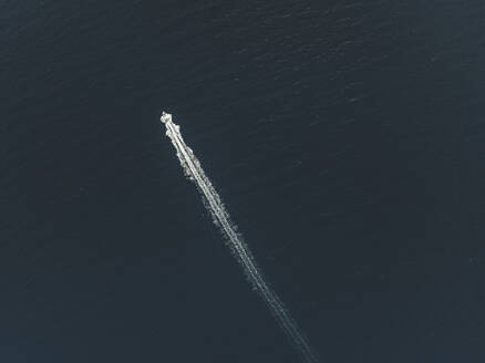Aerial view of a boat sailing in the sea of Sicily, Italy. - AAEF28676